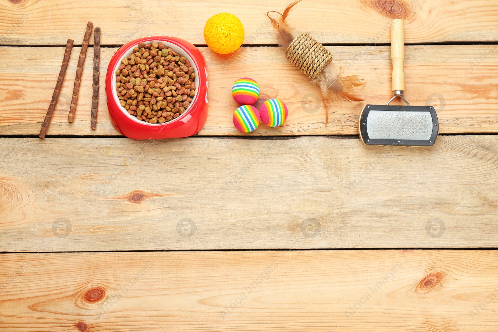 Photo of Flat lay composition with cat accessories and food on wooden background