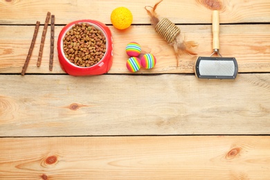 Photo of Flat lay composition with cat accessories and food on wooden background