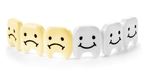 Image of Small plastic teeth with sad and happy faces on white background, banner design. Whitening concept