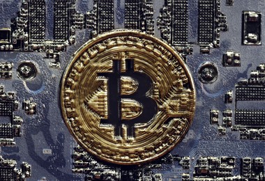 Image of Digital currency security. Golden bitcoin on computer circuit board