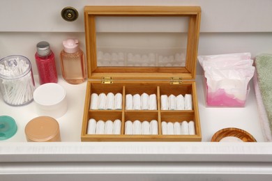 Storage of tampons and different hygiene products in white drawer