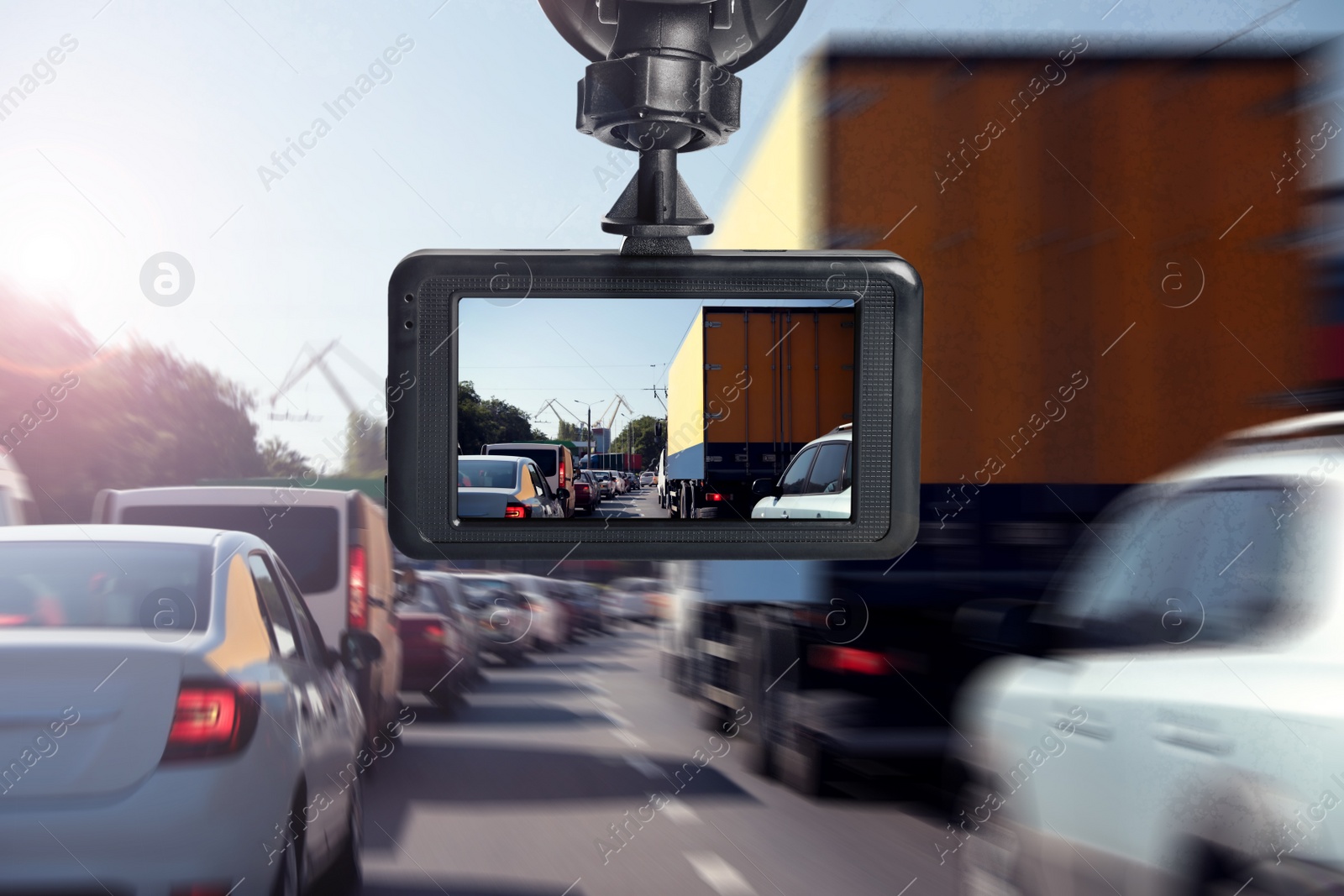 Image of Modern dashboard camera mounted in car, view of road during driving