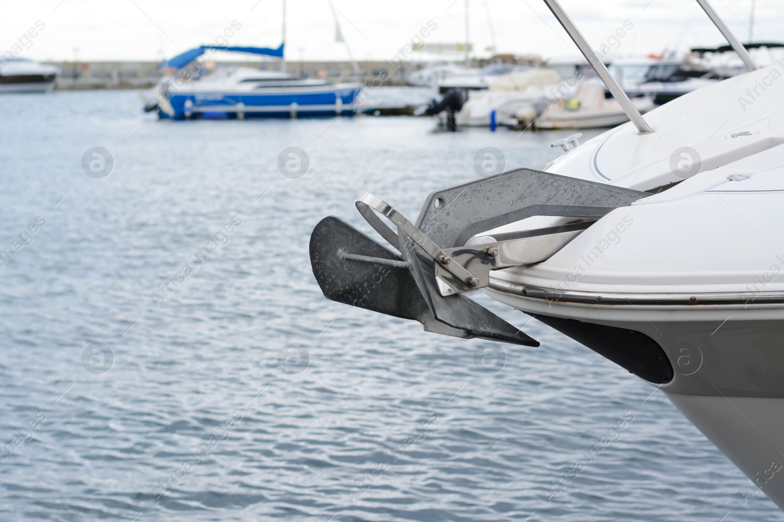 Photo of Huge and massive anchor of modern yacht moored in harbor near sea