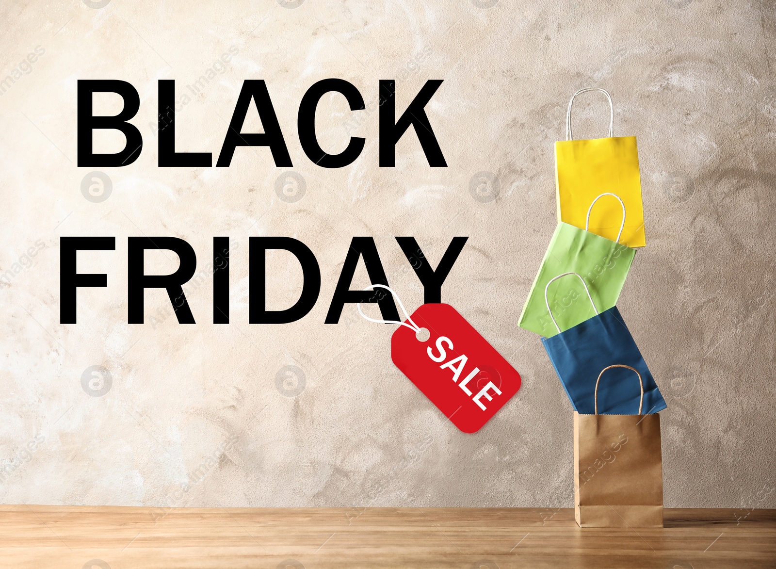 Image of Colorful shopping bags and text BLACK FRIDAY SALE on beige background