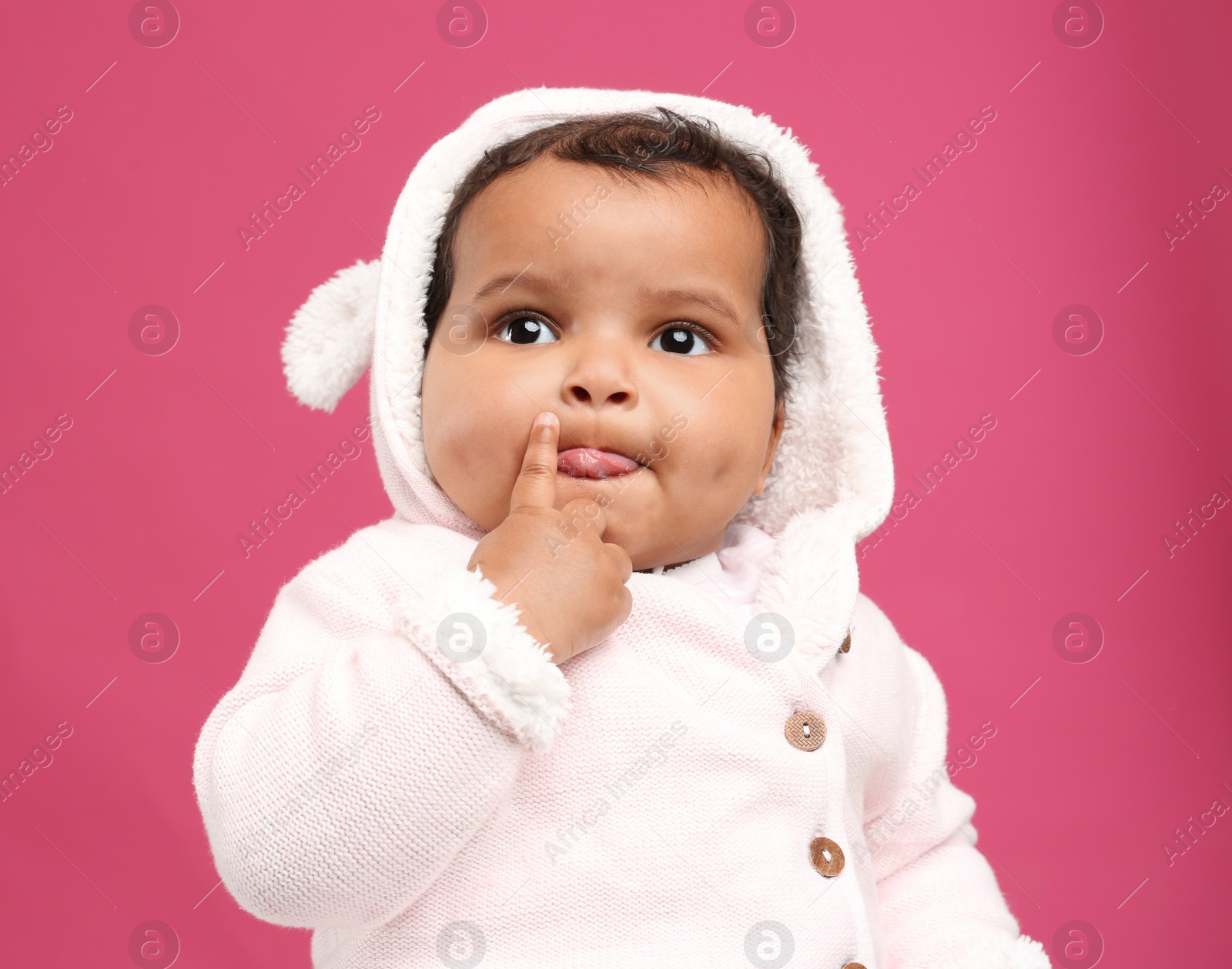 Photo of Cute African American baby on pink background