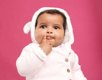 Photo of Cute African American baby on pink background