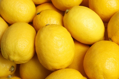 Photo of Many fresh ripe lemons as background, top view