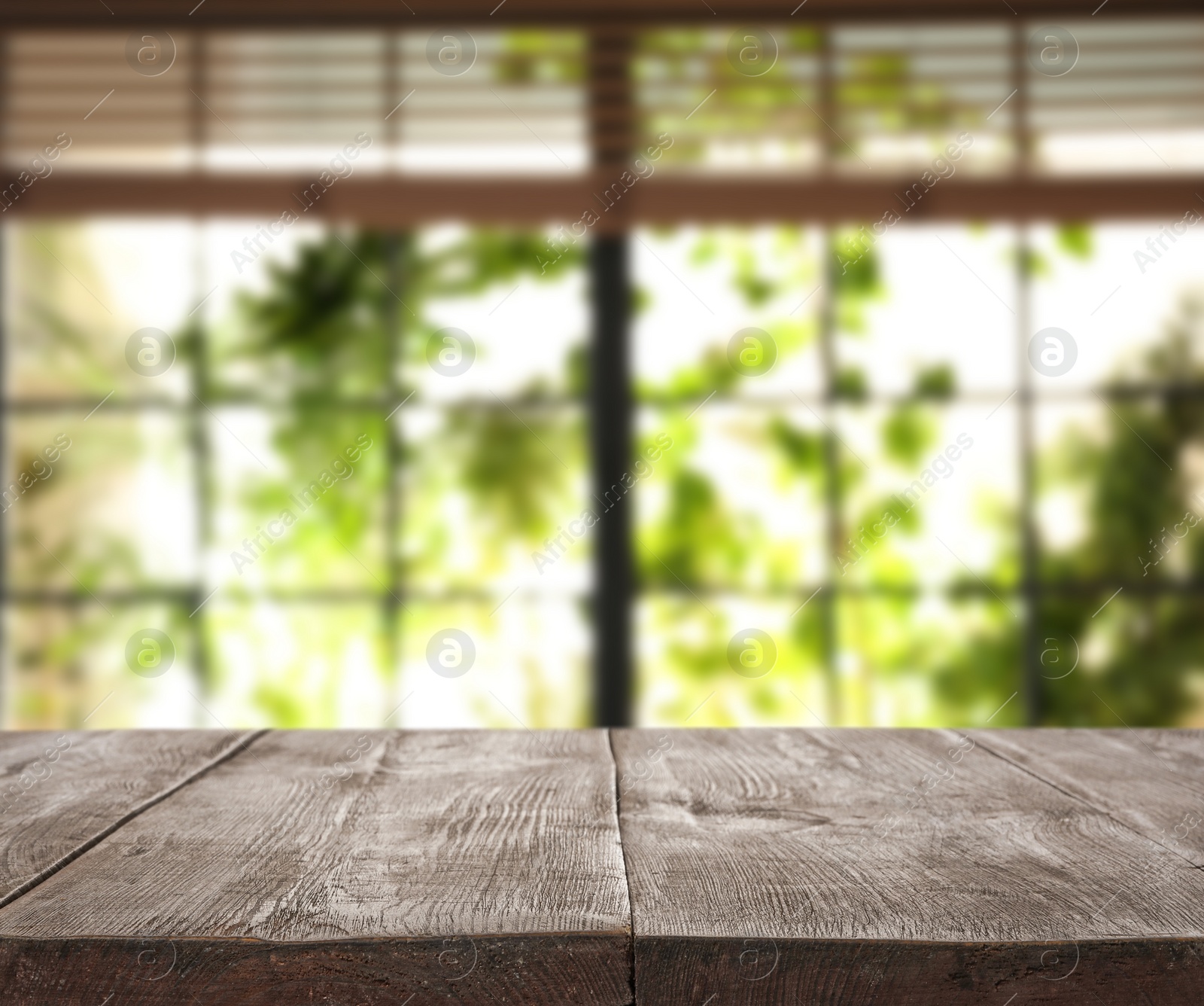 Image of Empty wooden table in front of window. Sunny morning 