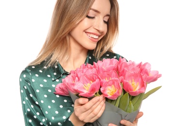 Portrait of smiling young girl with beautiful tulips on white background. International Women's Day