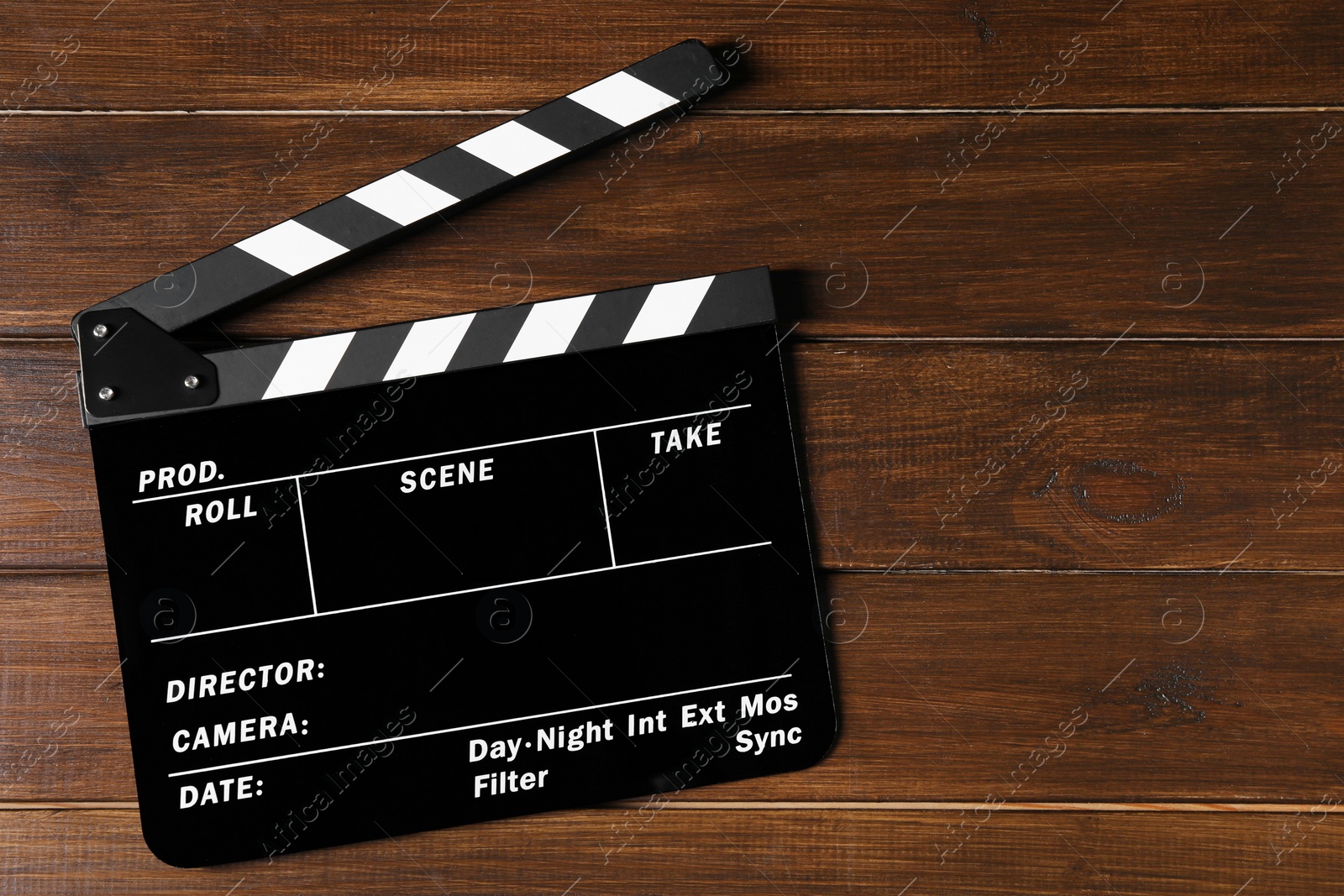 Photo of Clapperboard on wooden table, top view. Space for text