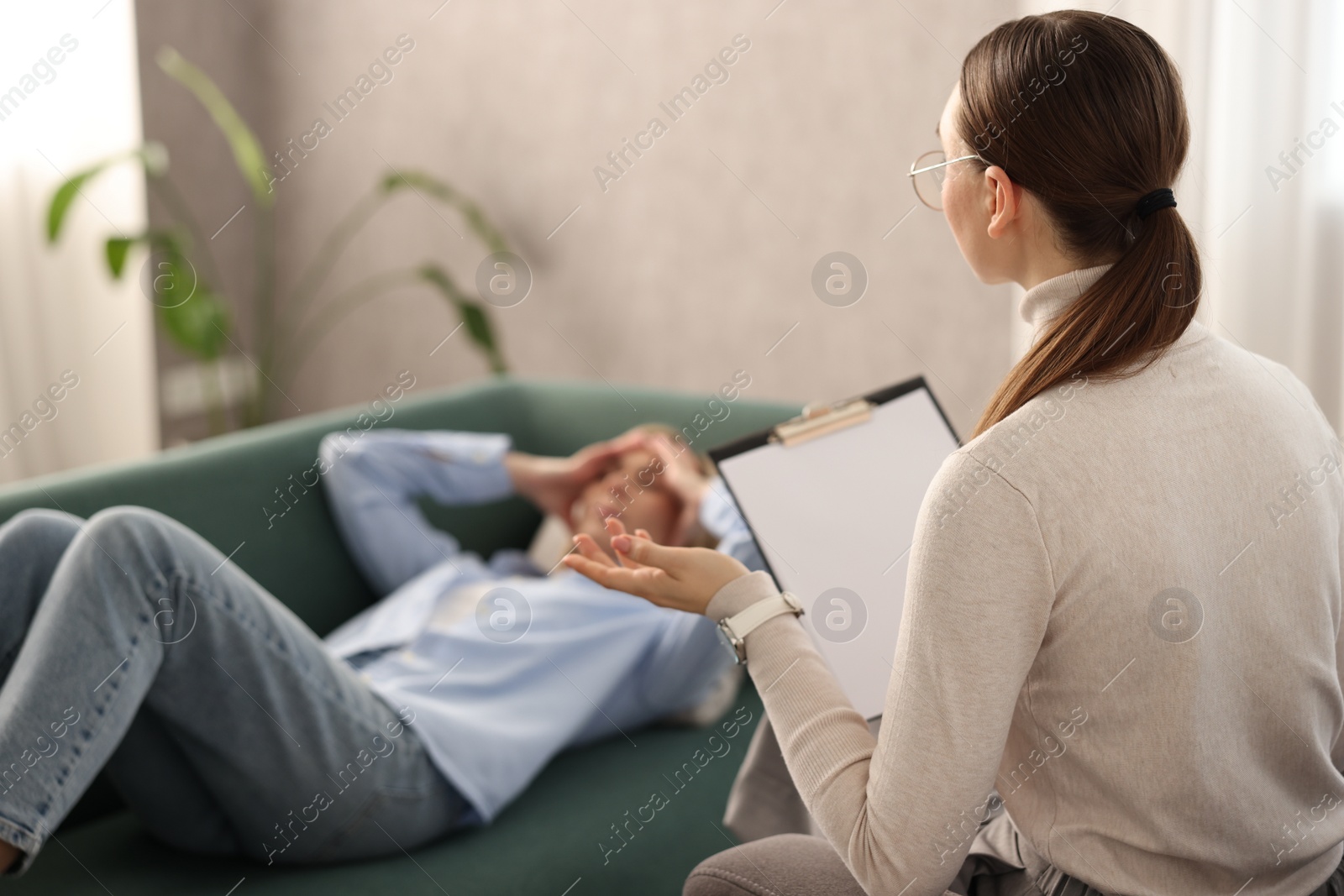 Photo of Professional psychotherapist working with patient in office