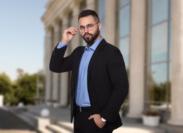 Image of Successful lawyer in glasses near building outdoors