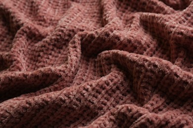 Photo of Beautiful pink knitted fabric as background, closeup