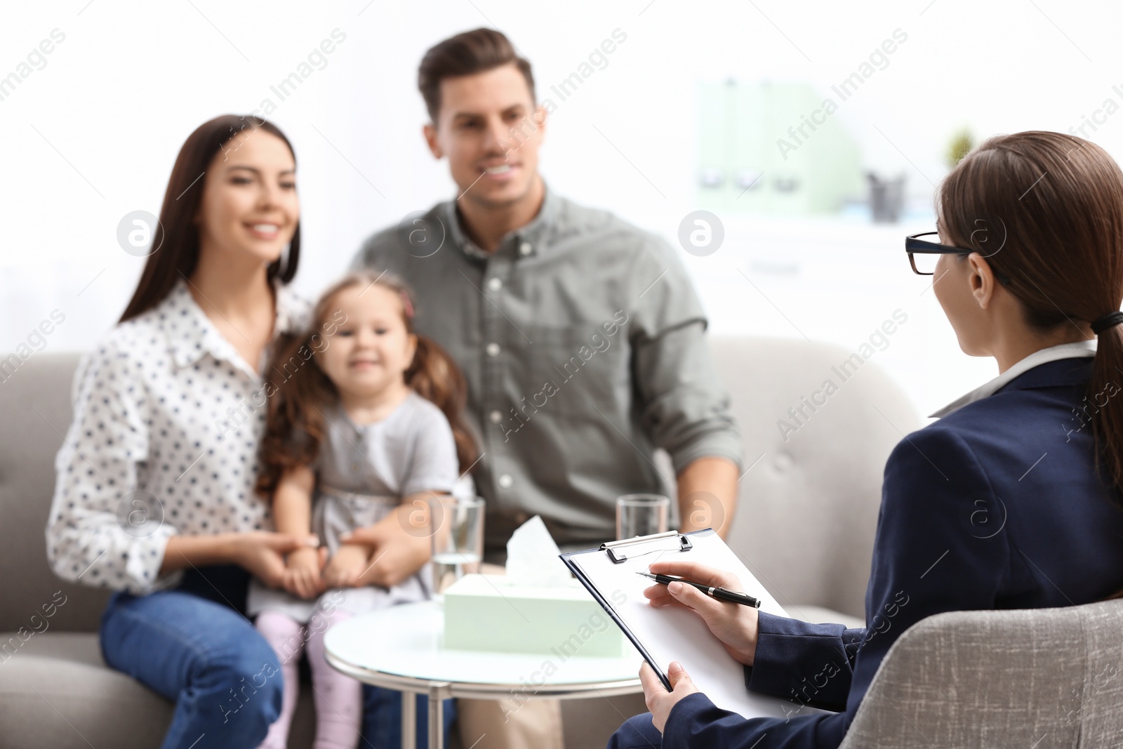 Photo of Professional psychologist working with family in office