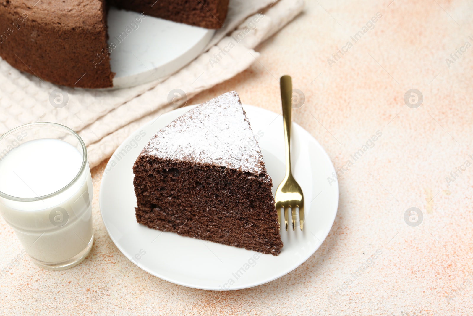 Photo of Piece of tasty chocolate sponge cake served on light table