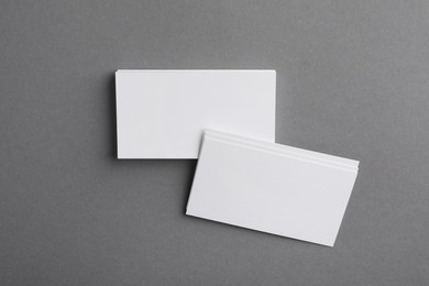 Photo of Blank business cards on grey background, top view. Mockup for design