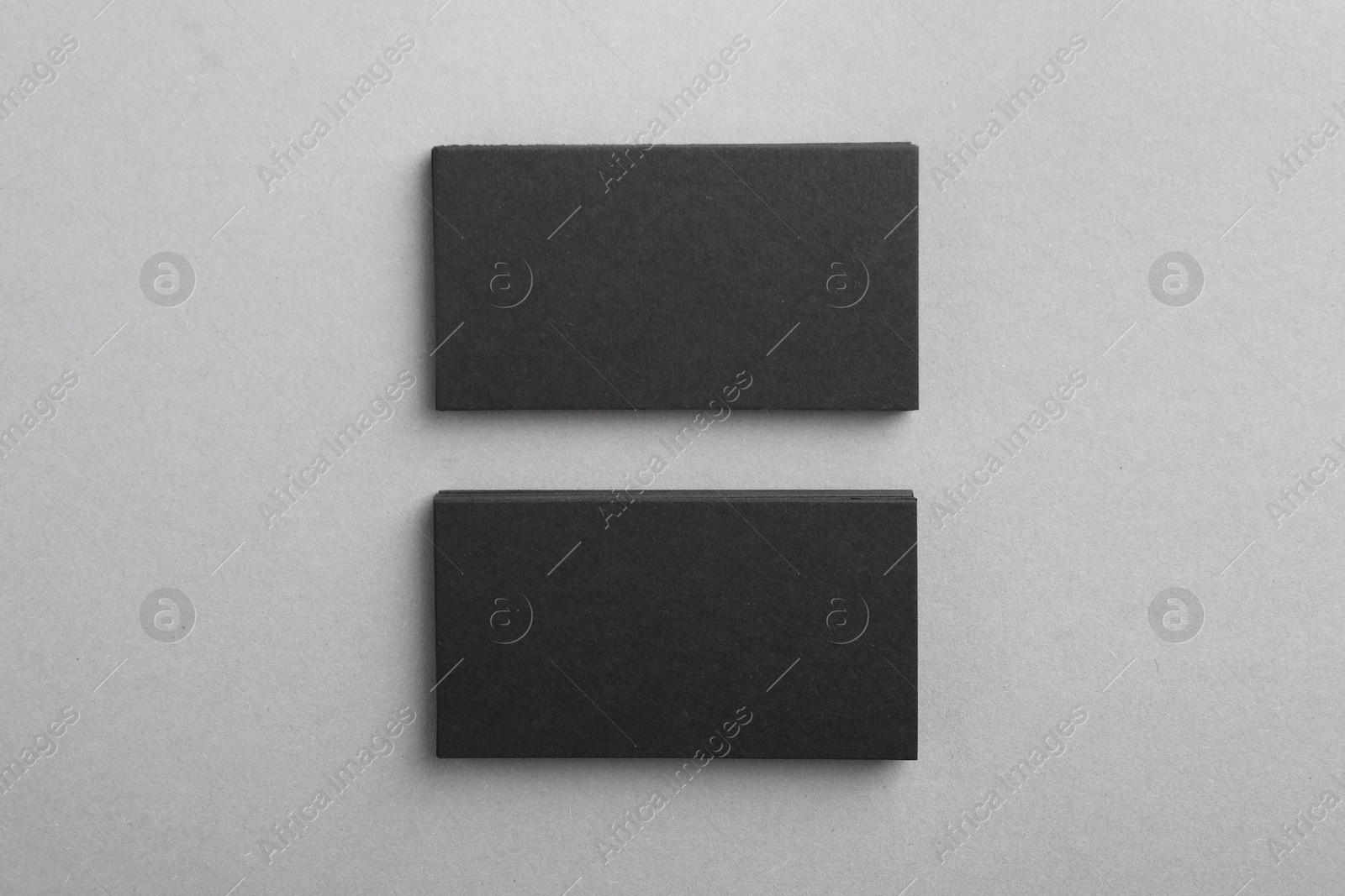 Photo of Blank business cards on grey background, top view. Mockup for design