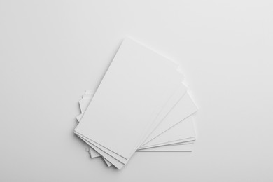 Blank business cards on light grey background, top view. Mockup for design