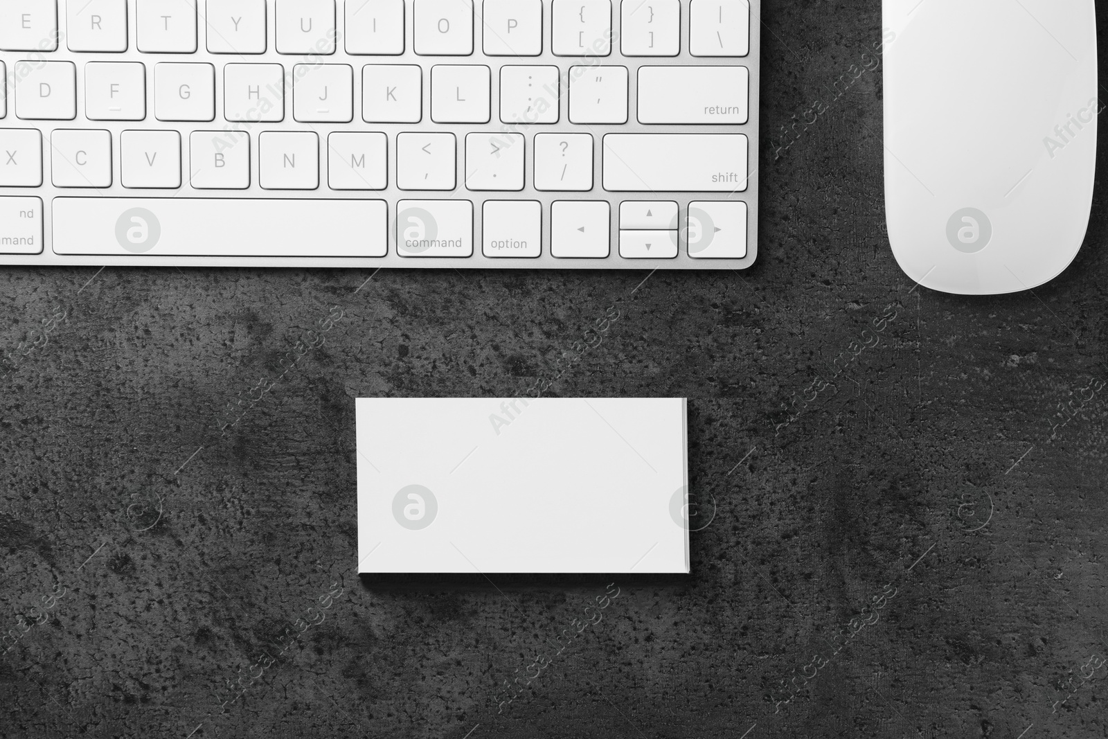 Photo of Blank business cards, computer mouse and keyboard on grey textured table, flat lay. Mockup for design