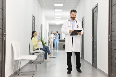 Photo of Patients waiting for appointment and doctors in hospital hallway, selective focus