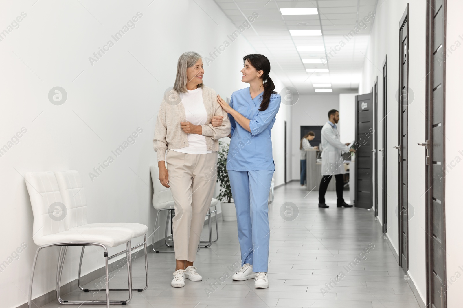 Photo of Nurse with senior woman in hospital hallway