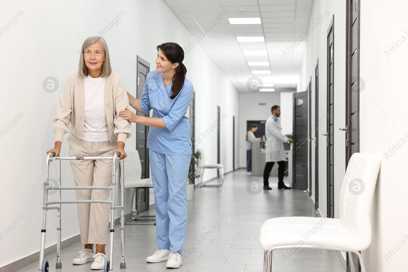 Photo of Nurse with senior woman in hospital hallway