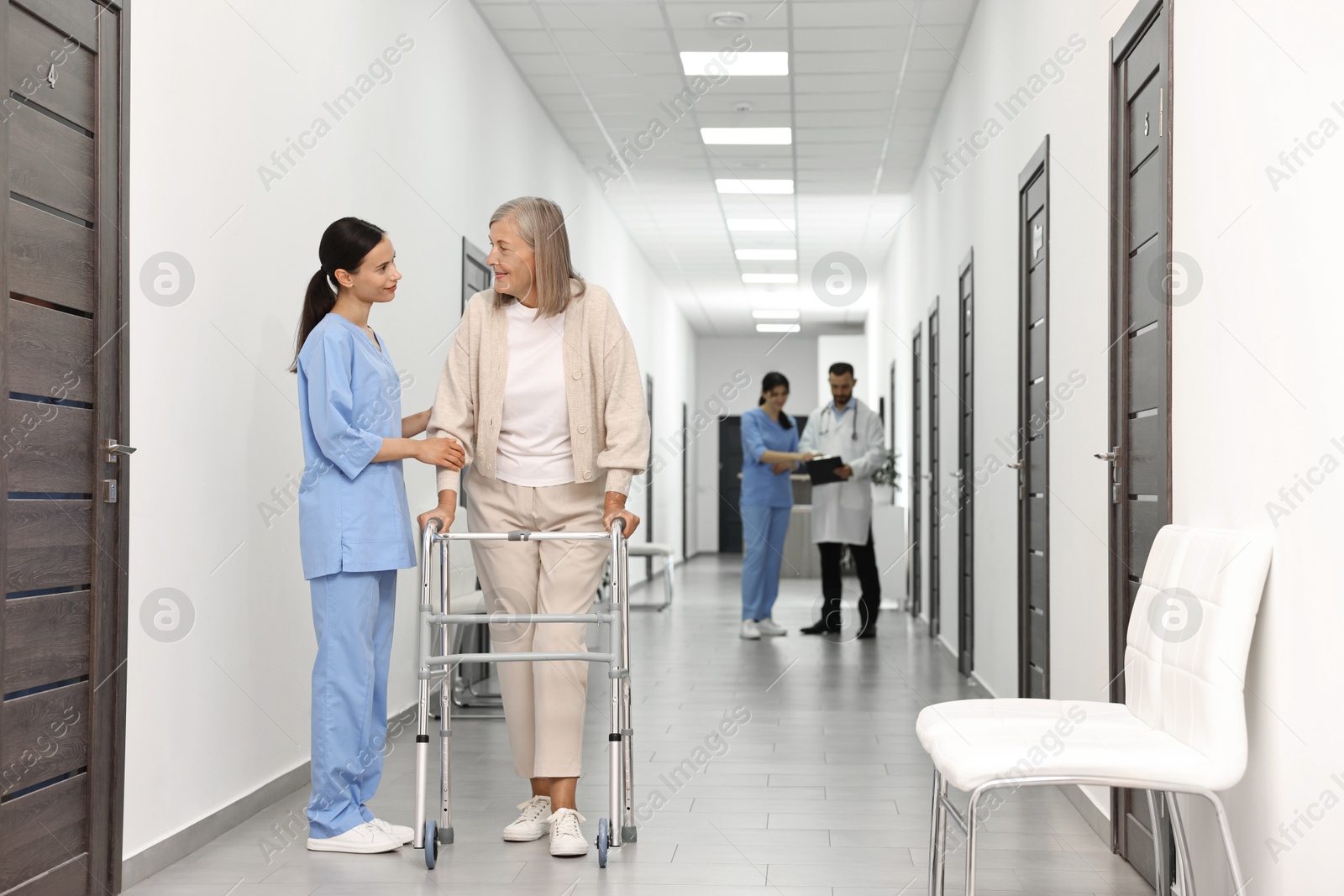 Photo of Nurse with senior woman in hospital hallway