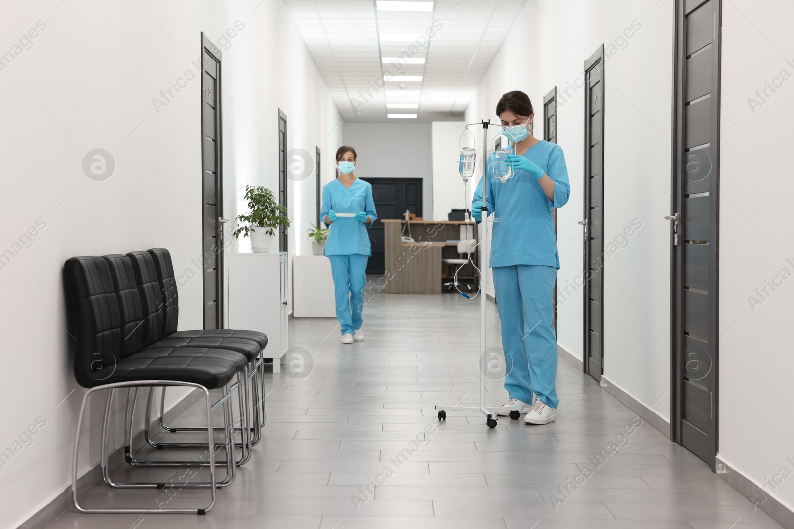 Photo of Nurses working with medical equipment in hospital hallway