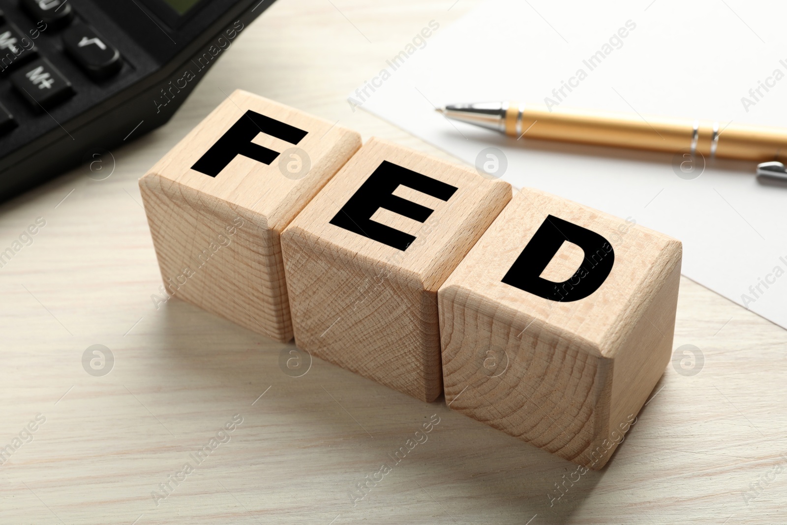 Photo of Wooden cubes with letters Fed (Federal Reserve System) on table