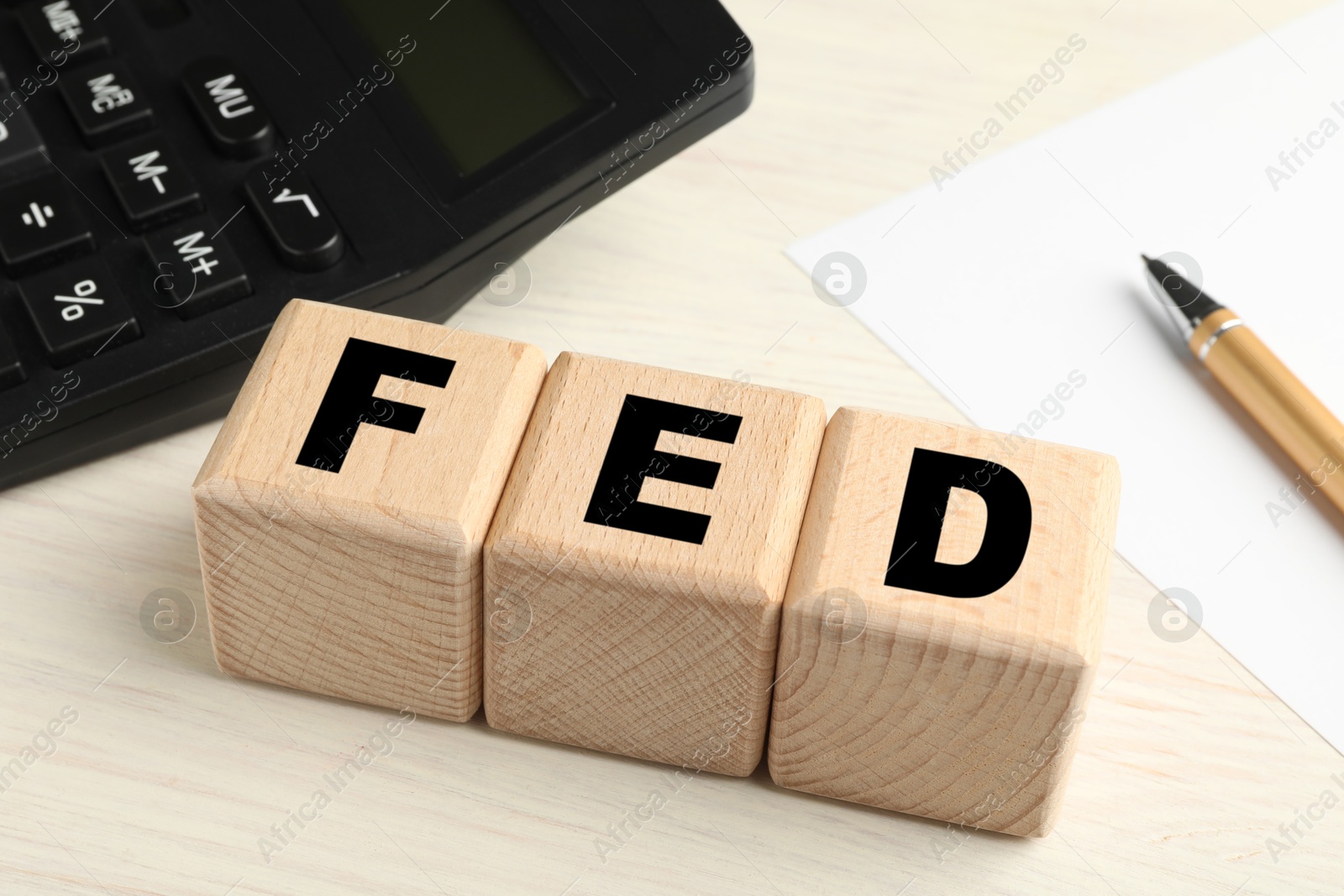 Photo of Wooden cubes with letters Fed (Federal Reserve System) on table