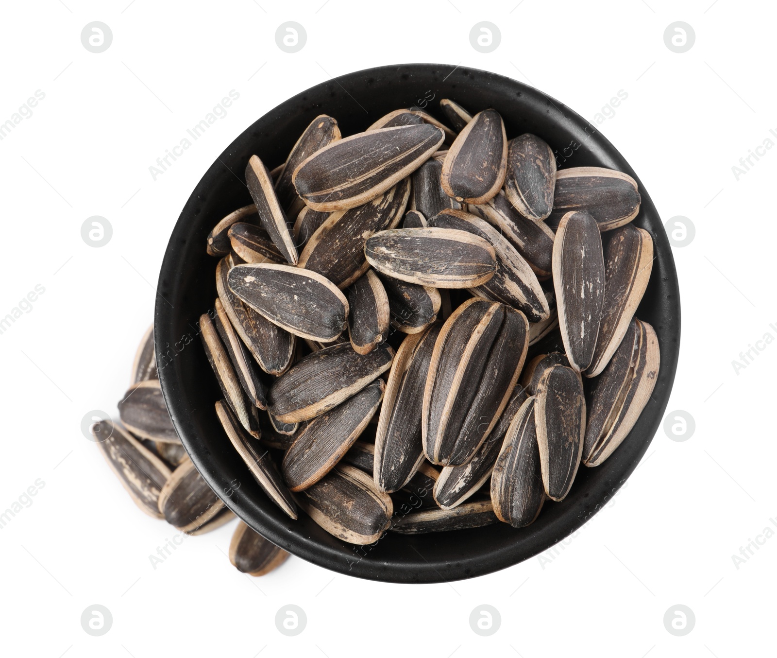 Photo of Sunflower seeds in bowl isolated on white, top view