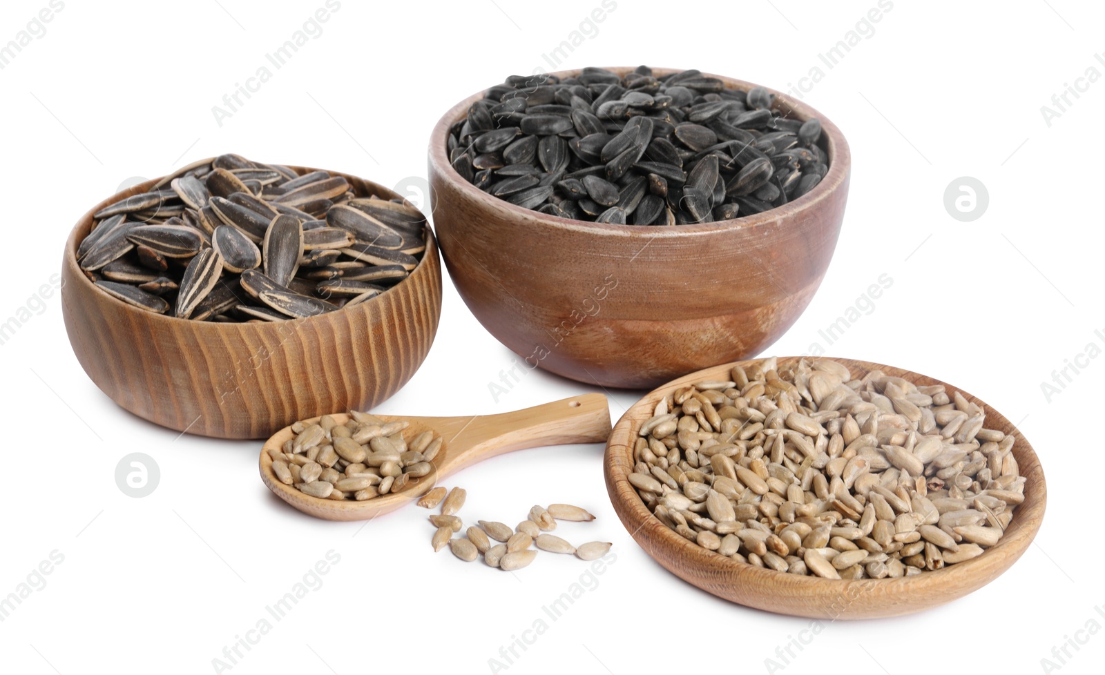 Photo of Different sunflower seeds in bowls and wooden spoon isolated on white