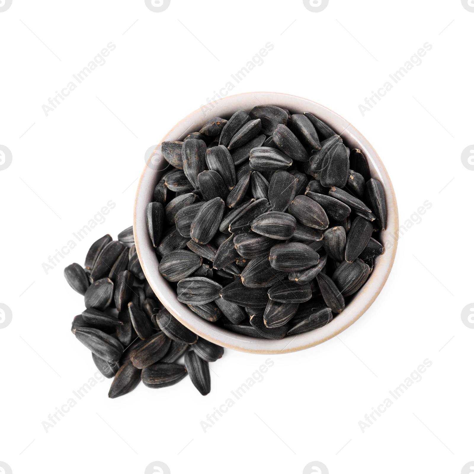 Photo of Sunflower seeds in bowl isolated on white, top view