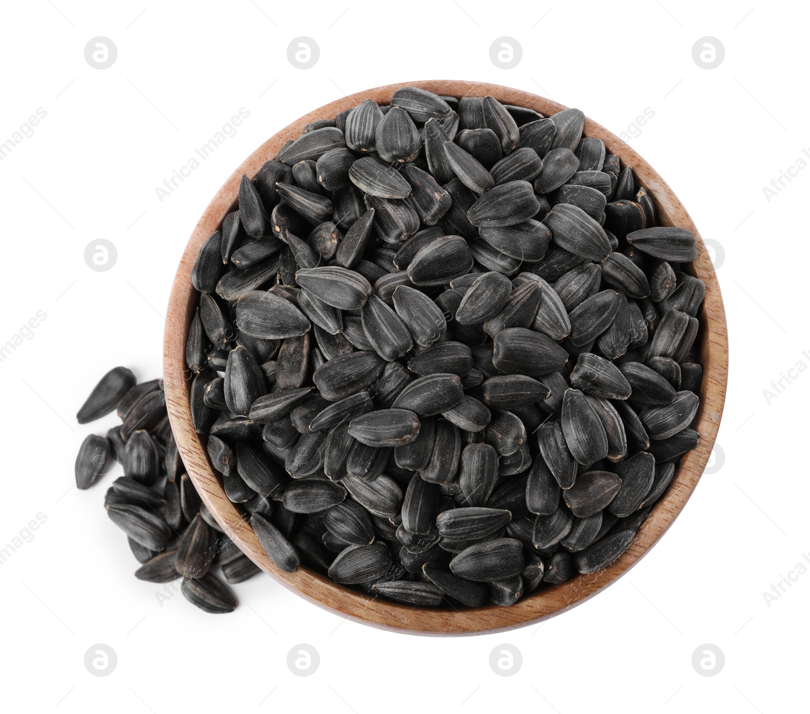 Photo of Sunflower seeds in wooden bowl isolated on white, top view