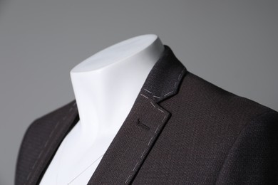 Photo of Semi-ready jacket on mannequin against grey background, closeup