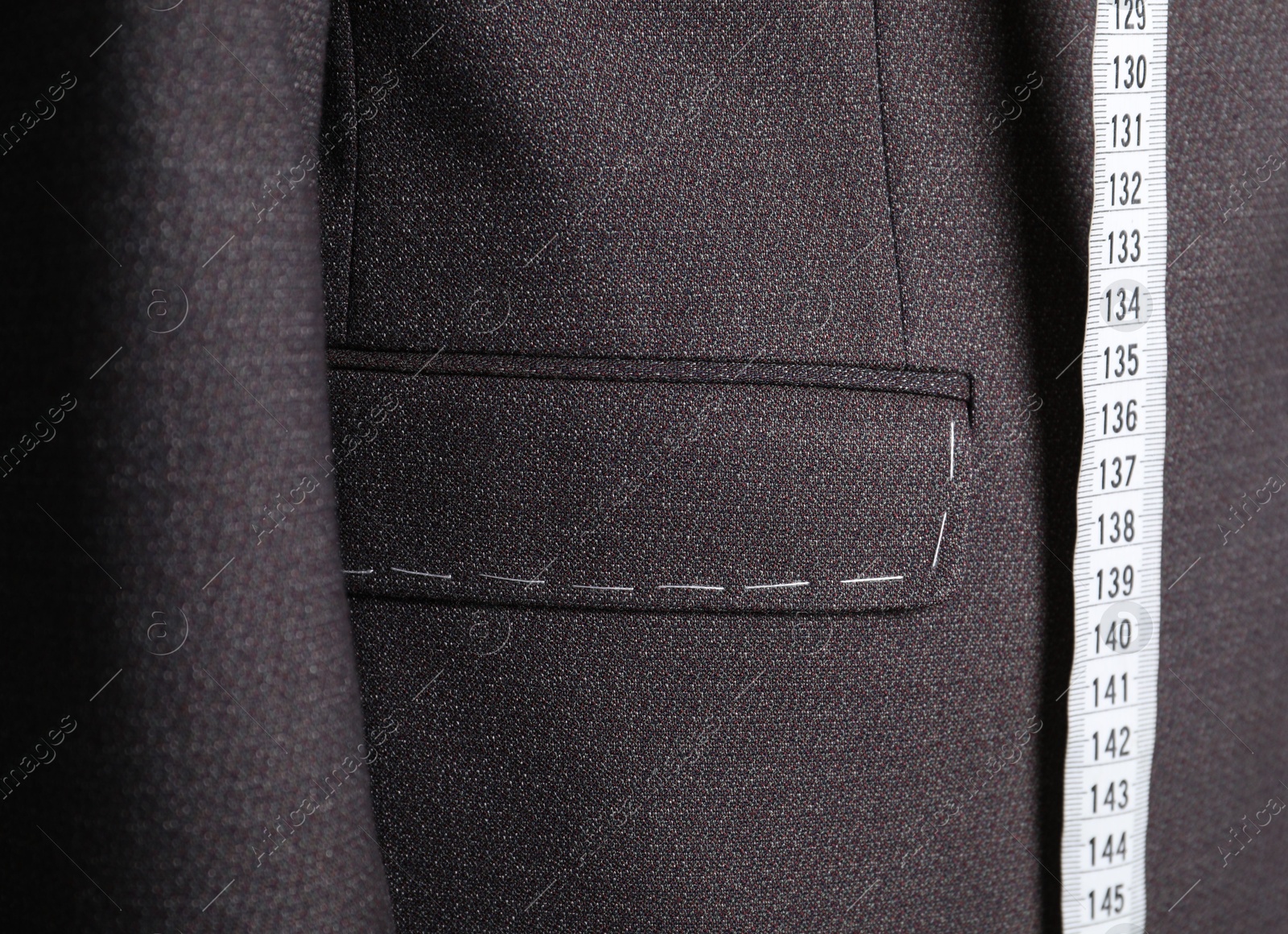 Photo of Semi-ready jacket with tailor's measuring tape, closeup