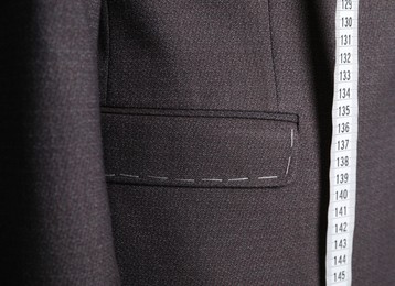 Semi-ready jacket with tailor's measuring tape, closeup