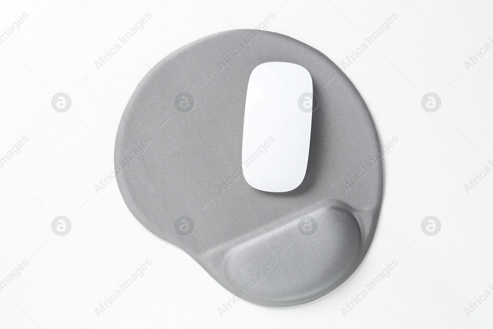 Photo of Mouse and mousepad with arm rest on white table, top view