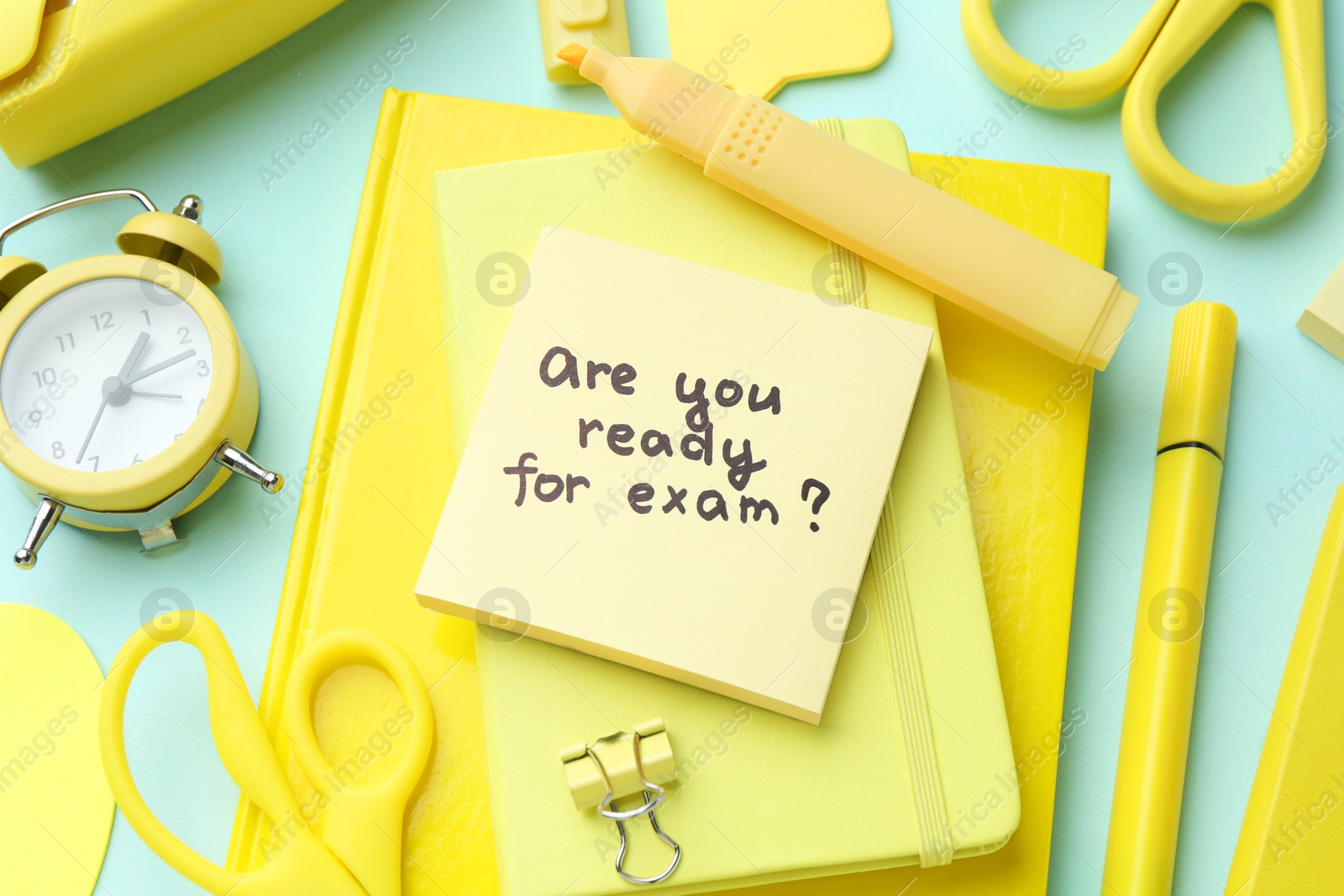 Photo of Paper note with question Are You Ready For Exam and stationery on light blue background, above view