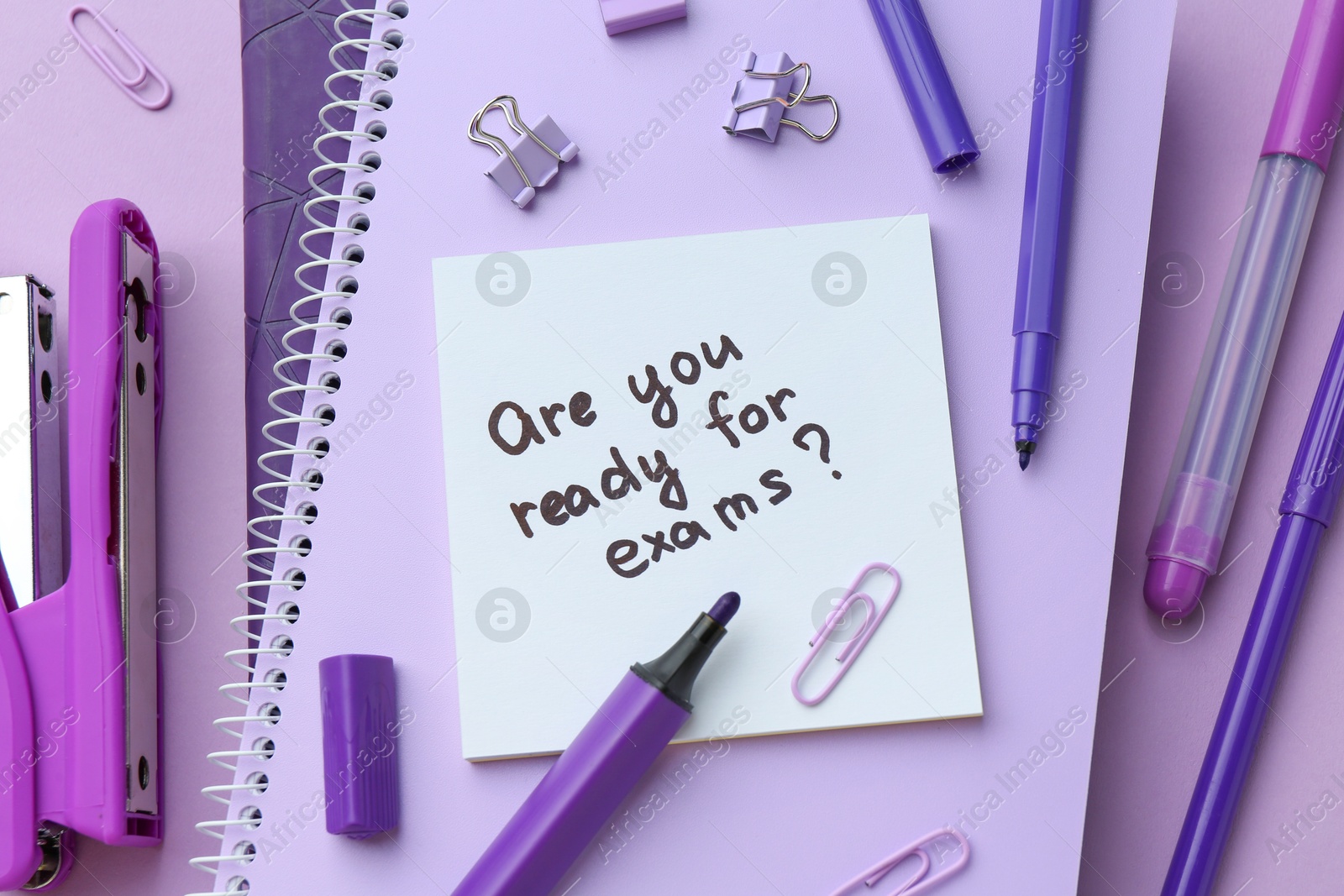 Photo of Paper note with question Are You Ready For Exams and stationery on purple background, flat lay