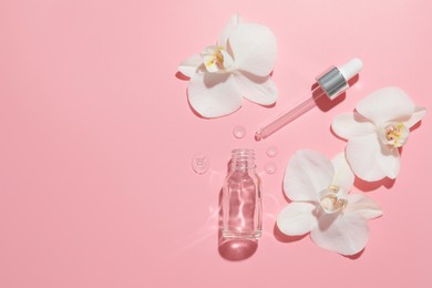 Photo of Beautiful orchid flowers and essential oil in water on pink background, flat lay. Space for text