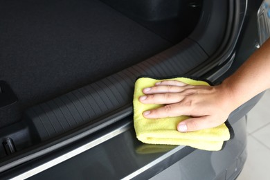 Man wiping auto with rag at car wash, closeup