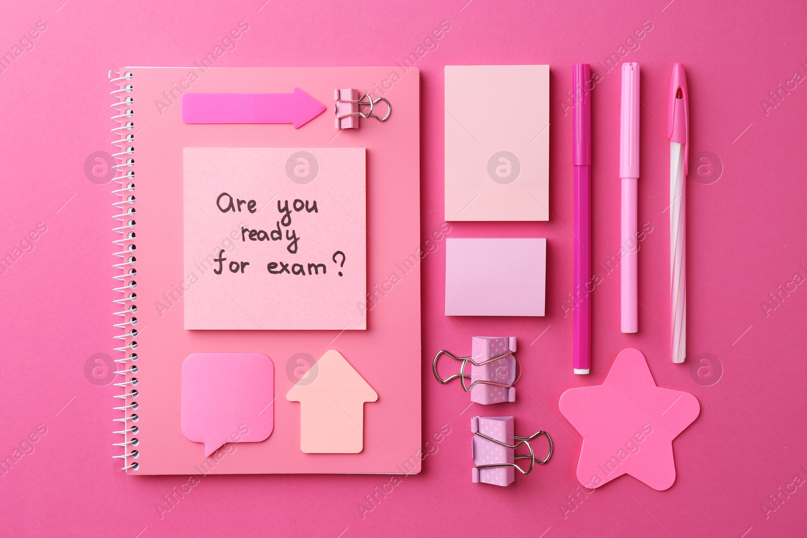 Photo of Paper note with question Are You Ready For Exam and stationery on pink background, flat lay