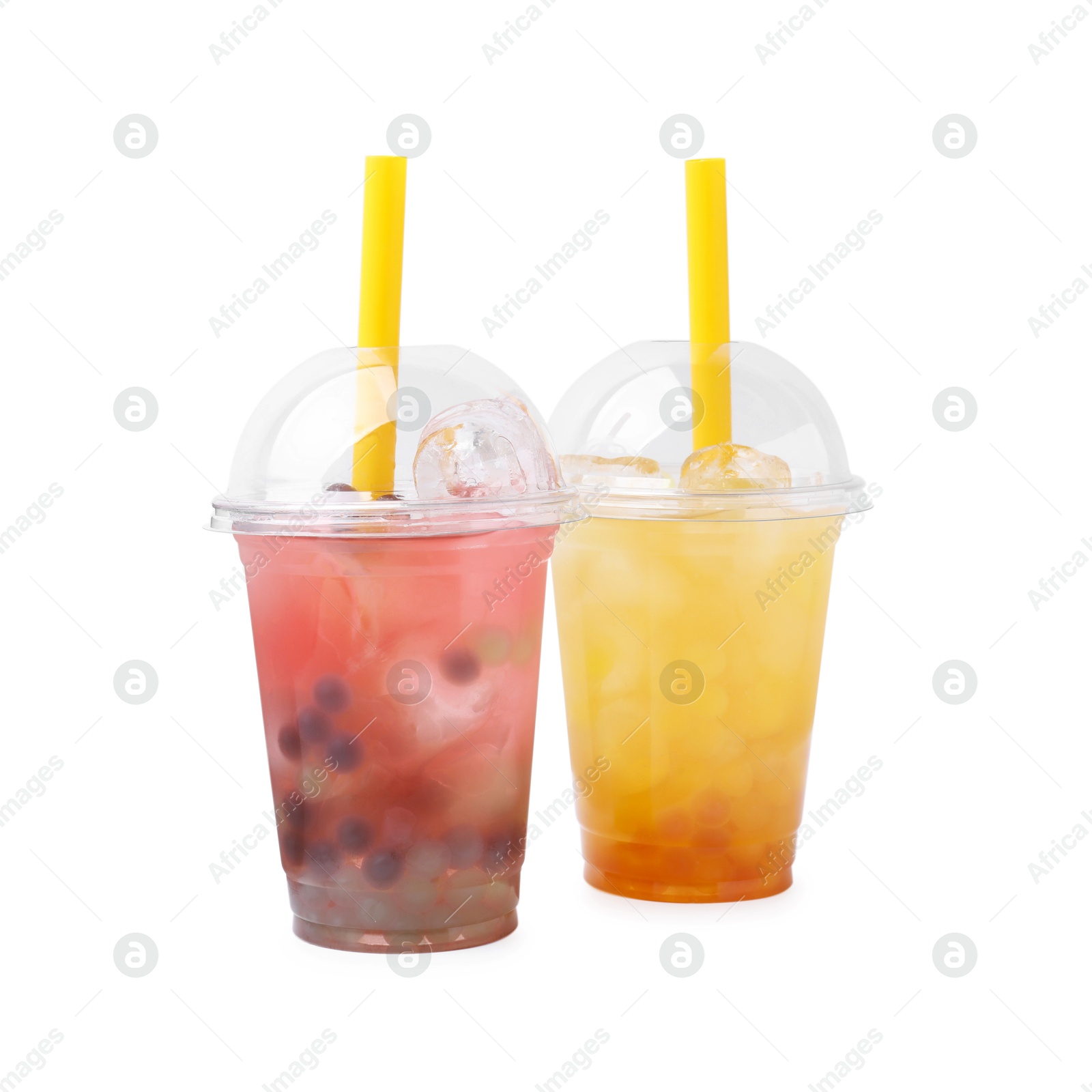 Photo of Tasty bubble tea in plastic cups isolated on white