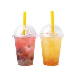 Photo of Tasty bubble tea in plastic cups isolated on white