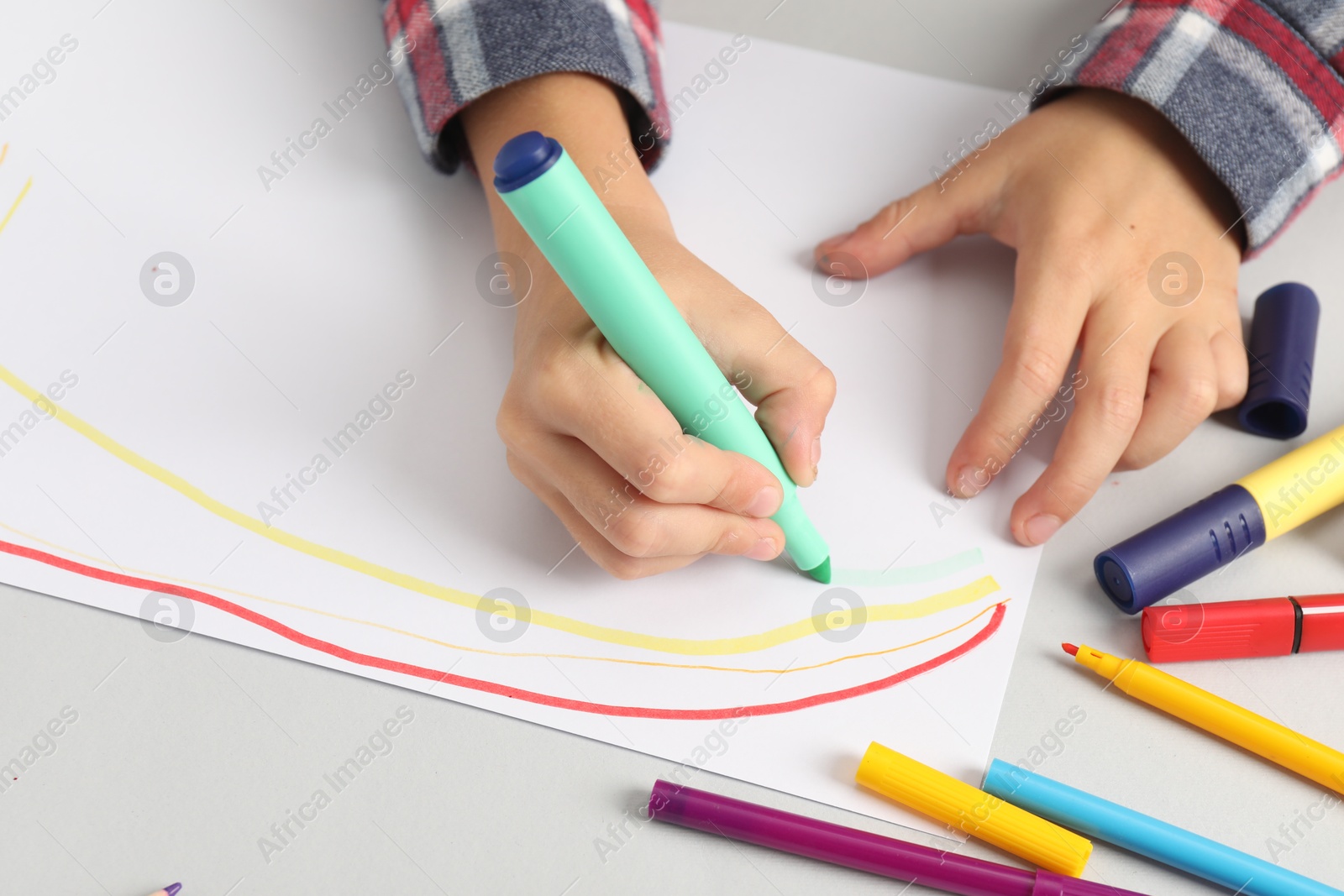 Photo of Boy drawing picture at light table, closeup