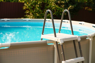 Above ground swimming pool outdoors on sunny day