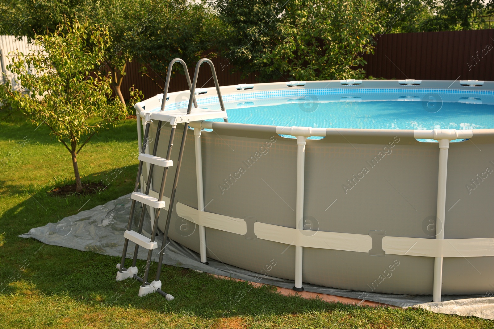 Photo of Above ground swimming pool outdoors on sunny day