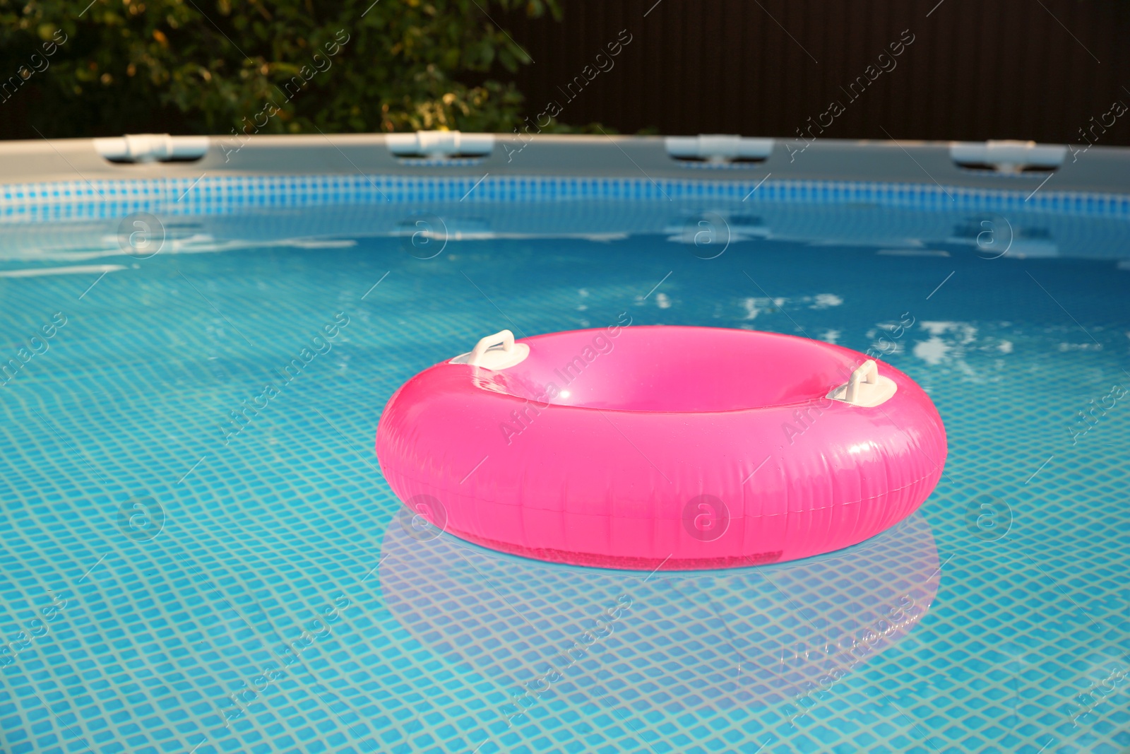 Photo of Inflatable ring on water in swimming pool outdoors