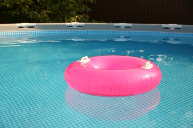 Inflatable ring on water in swimming pool outdoors